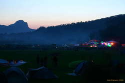 Campfires at sunset, and a decorated stage