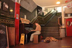 Enjoying a publicly accessible piano with his dog