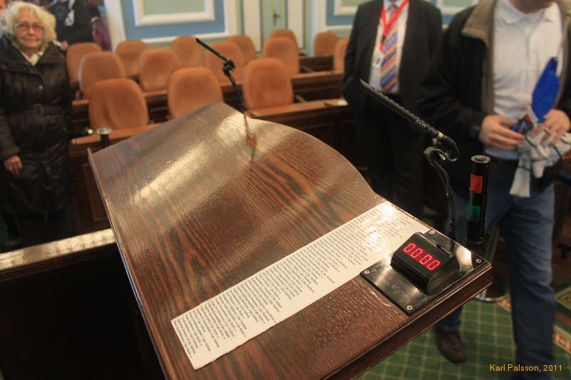 The speaker's lectern has a cheat sheet of members of parliarment